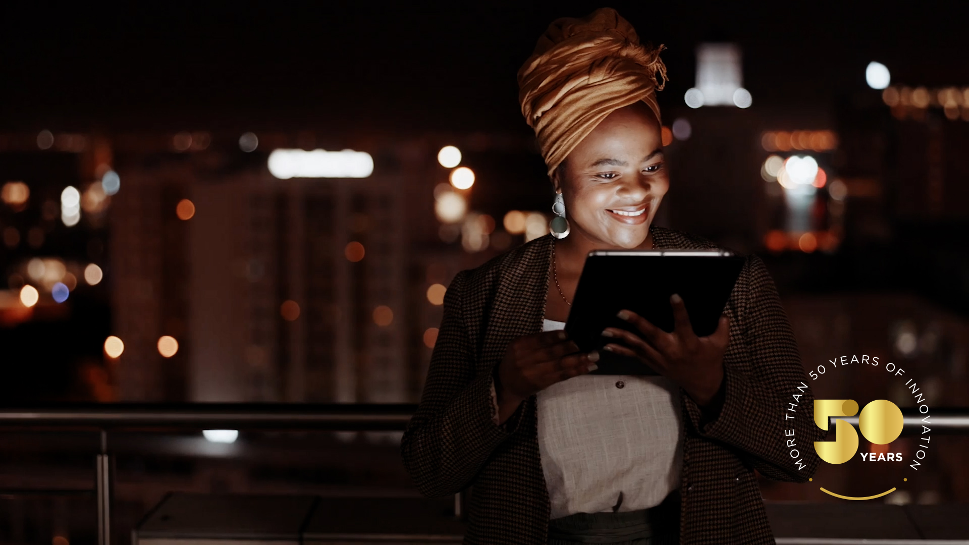 Happy girl, holding a tablet, looking at a screen smiling 