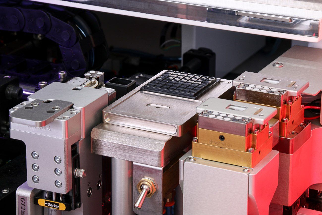 MRSI-HVM epoxy stamping well, output station, & integrated eutectic stages on shuttle