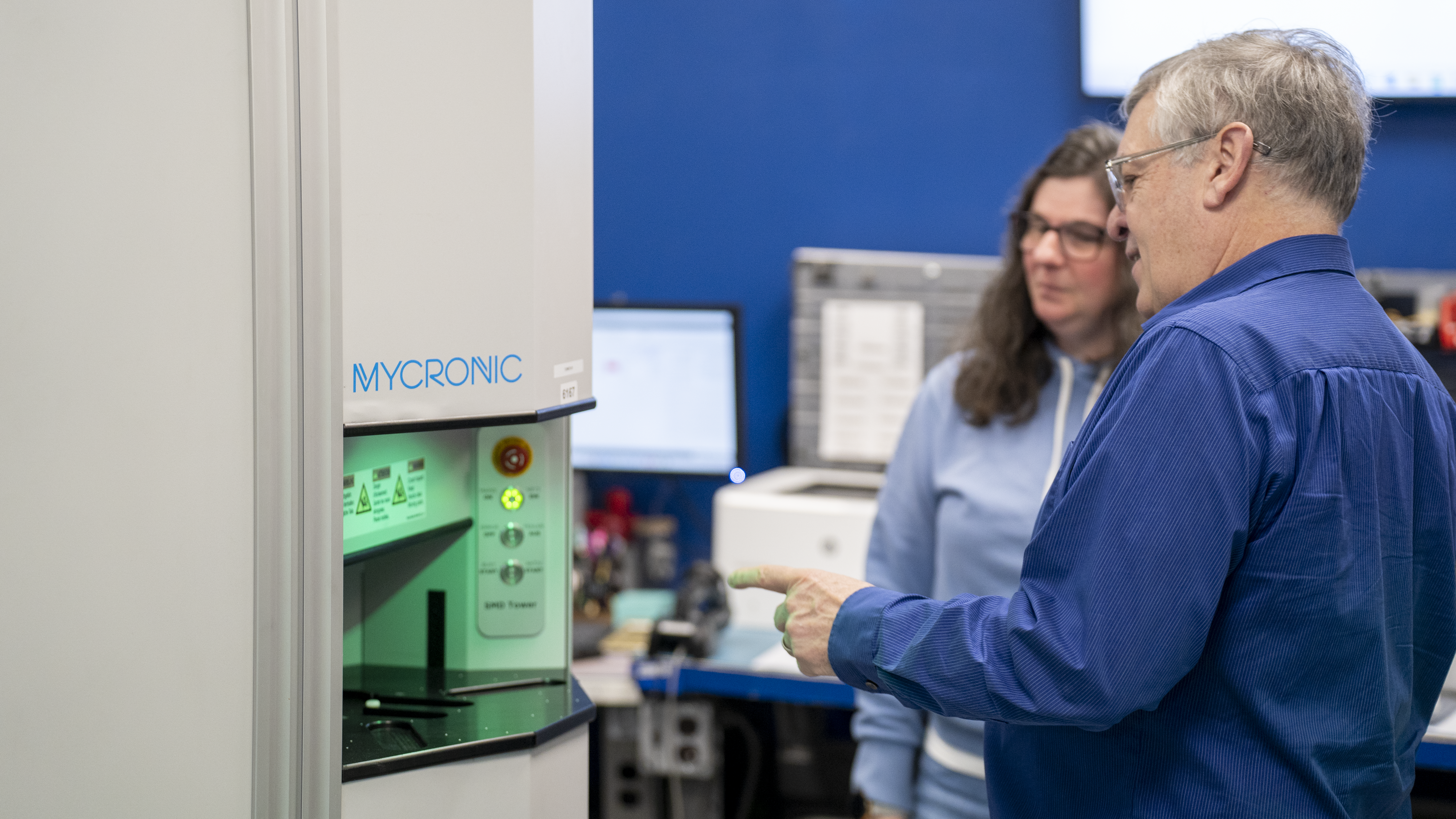 Z-AXIS owner talking with team member about Mycronic MYTower