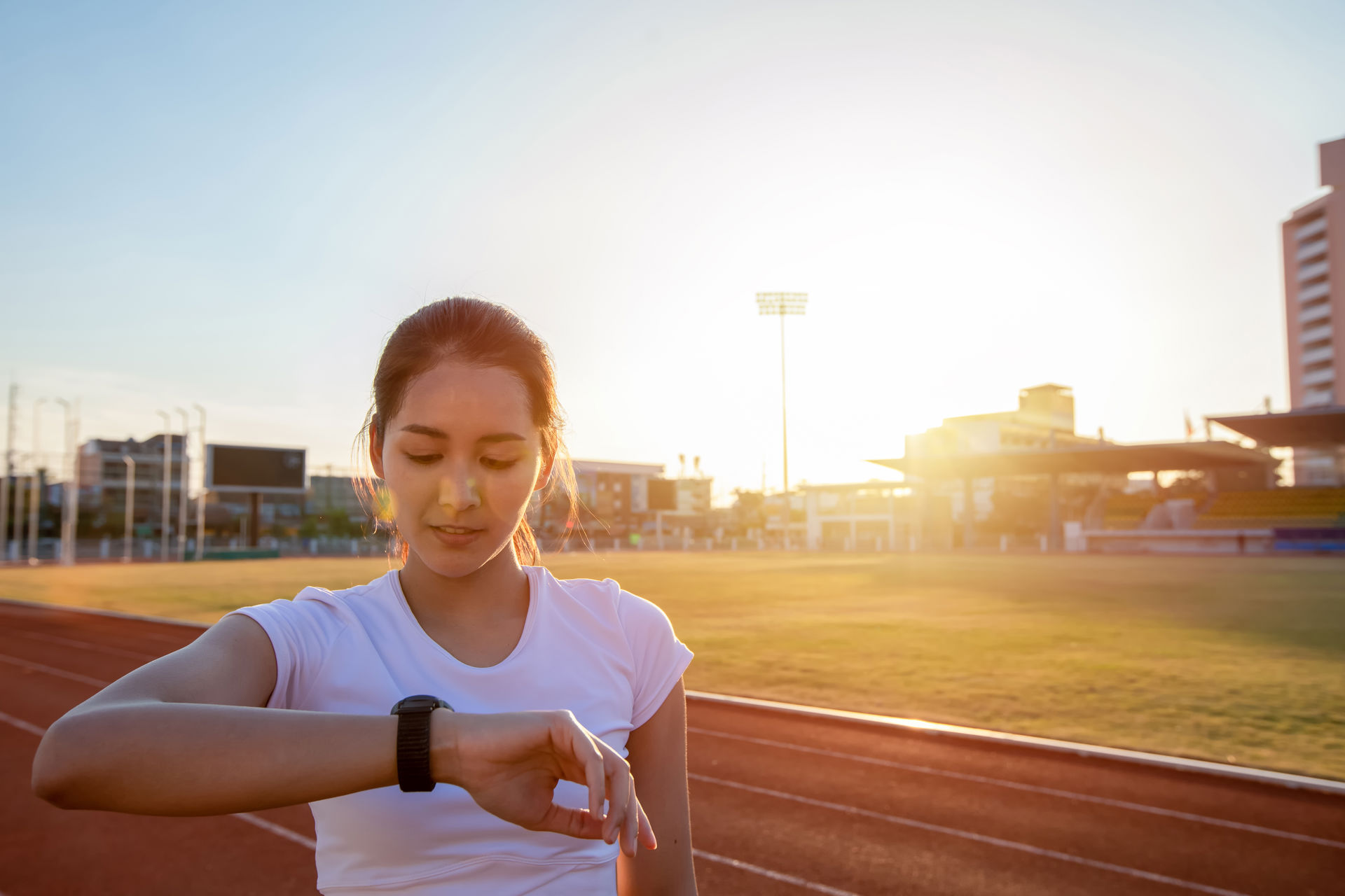 Woman with a smartwatch running in the sun