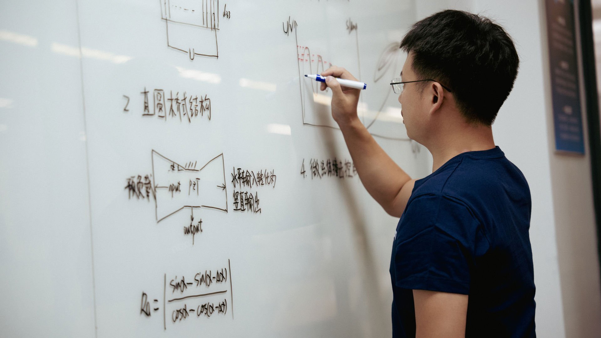 Man writing on a board at Axxon